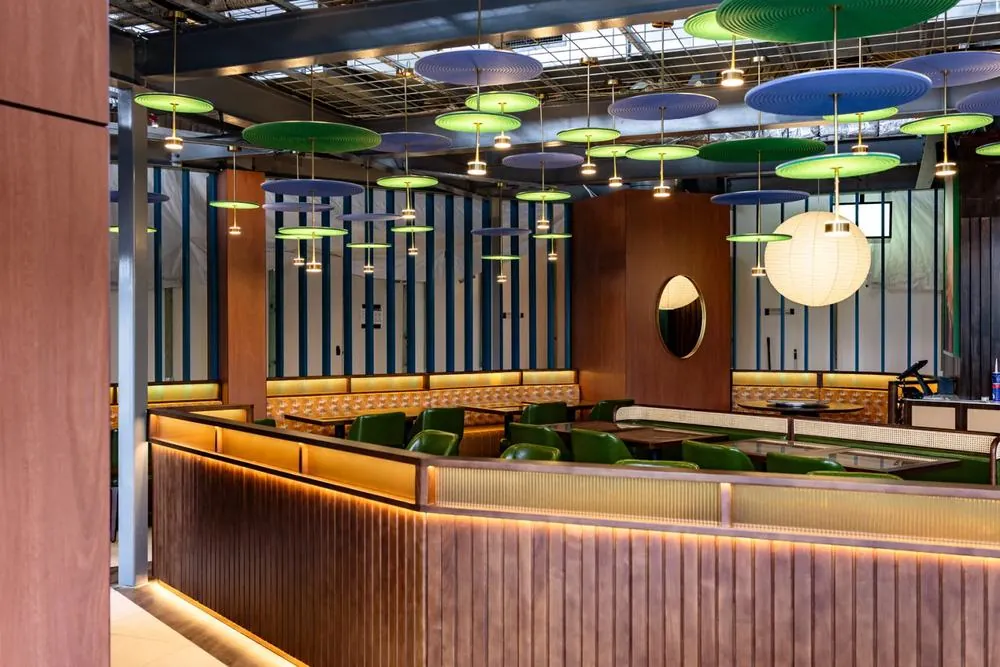 Main dining room at Jade Room with lantern-lined ceiling and long tables